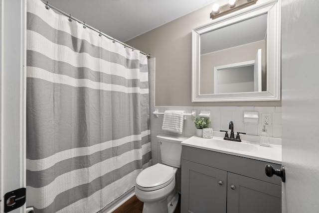 bathroom with backsplash, vanity, wood-type flooring, tile walls, and toilet