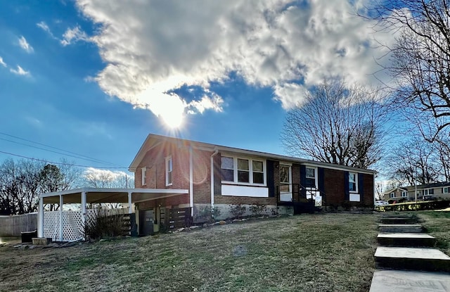 view of front of property with a carport and a front yard