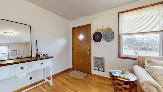 entryway with heating unit and light wood-type flooring