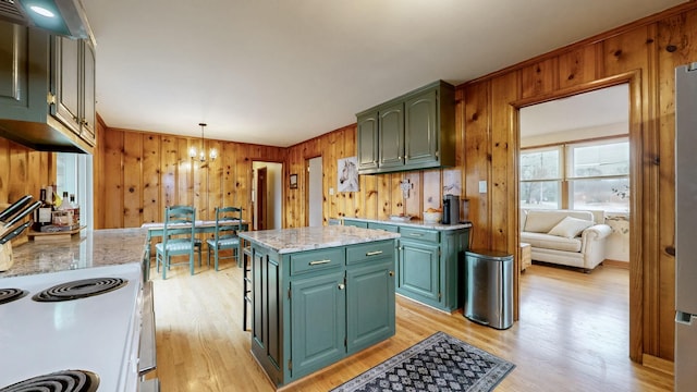 kitchen featuring hanging light fixtures, light hardwood / wood-style floors, a center island, and green cabinets