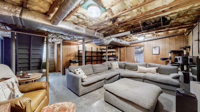 living room with wooden walls and concrete floors