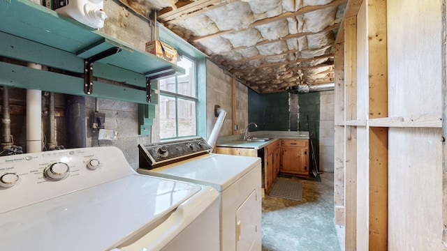 washroom featuring cabinets, separate washer and dryer, and sink