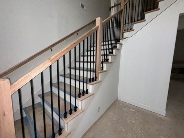 staircase with concrete floors