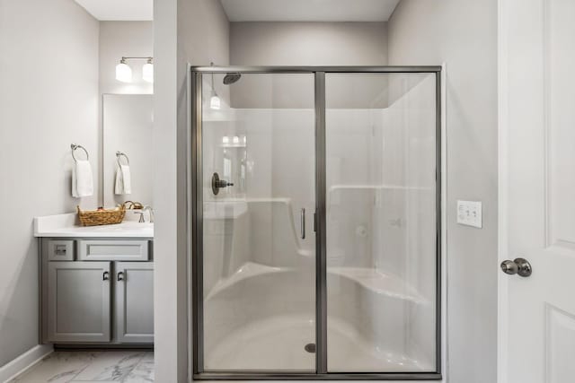 bathroom with vanity and a shower with shower door