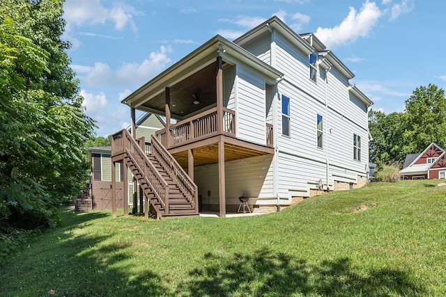 rear view of property with ceiling fan, a yard, and a wooden deck