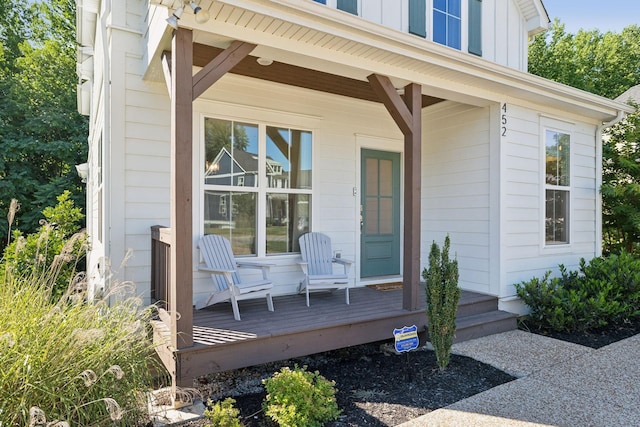 view of exterior entry featuring covered porch