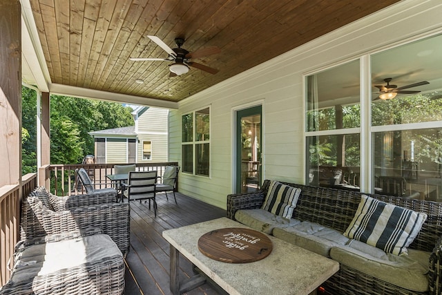 deck with outdoor lounge area and ceiling fan