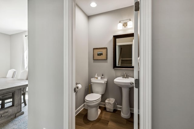 bathroom featuring sink, hardwood / wood-style floors, and toilet