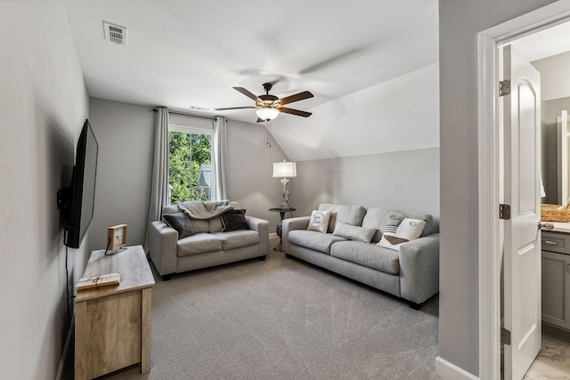 carpeted living room with ceiling fan and lofted ceiling