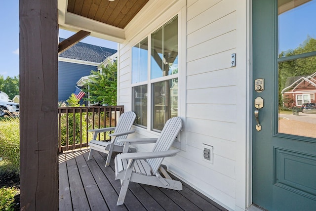 wooden terrace featuring covered porch