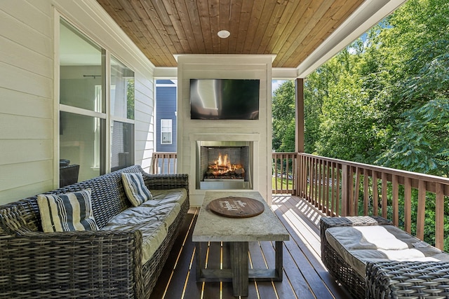 wooden terrace with a large fireplace