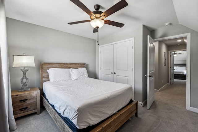 carpeted bedroom with a closet, vaulted ceiling, and ceiling fan