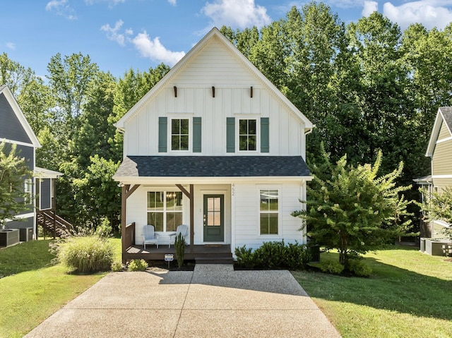 modern farmhouse style home with a porch and a front yard