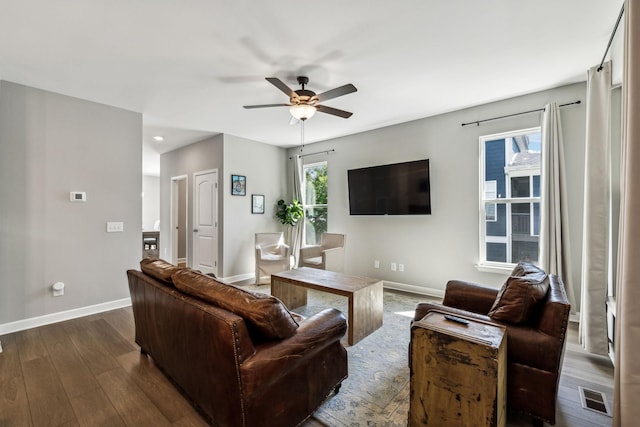 living room featuring dark hardwood / wood-style flooring and ceiling fan