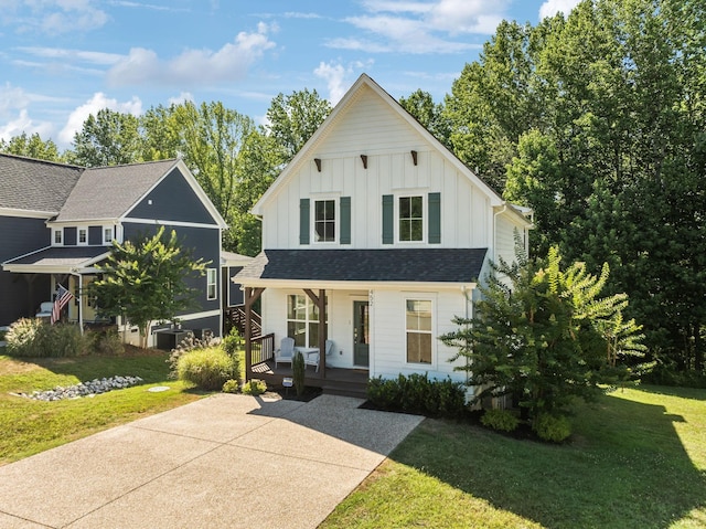 modern inspired farmhouse with a front yard and a porch