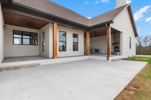 rear view of property with a fireplace, a patio, and ceiling fan