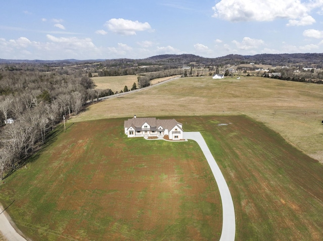 drone / aerial view featuring a mountain view and a rural view