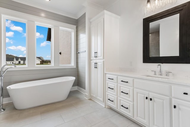 bathroom with tile patterned flooring, vanity, and a tub