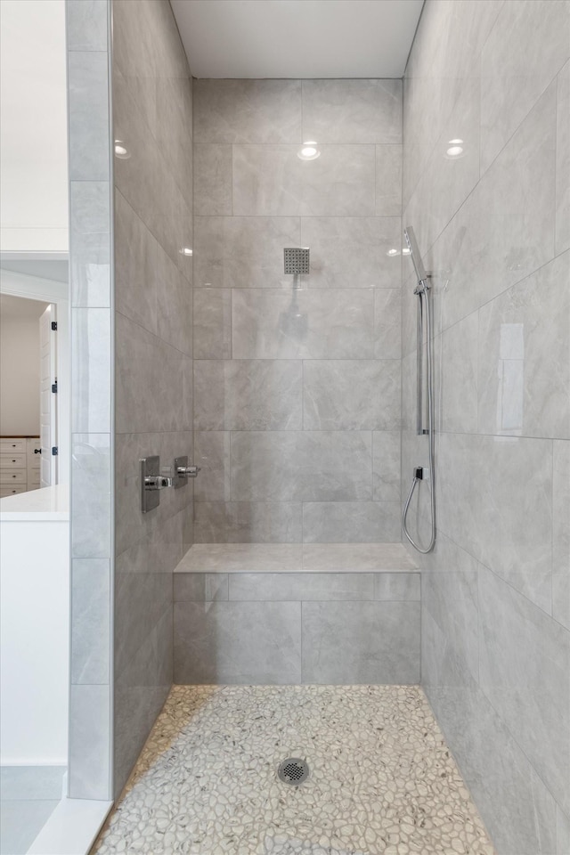 bathroom with a tile shower