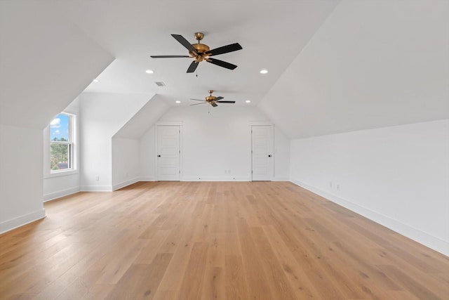 bonus room with ceiling fan, light hardwood / wood-style flooring, and vaulted ceiling