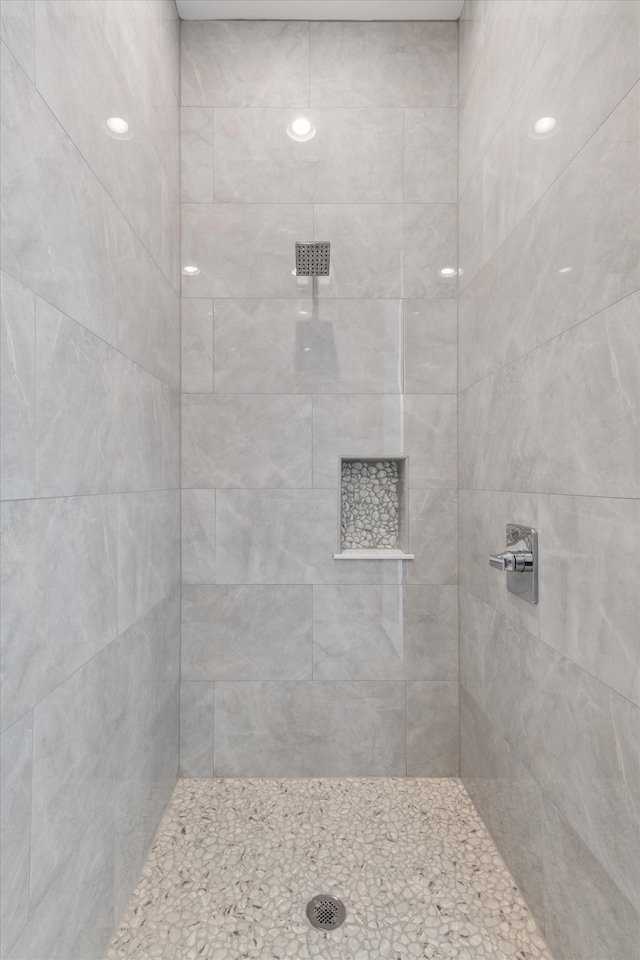 bathroom with tiled shower