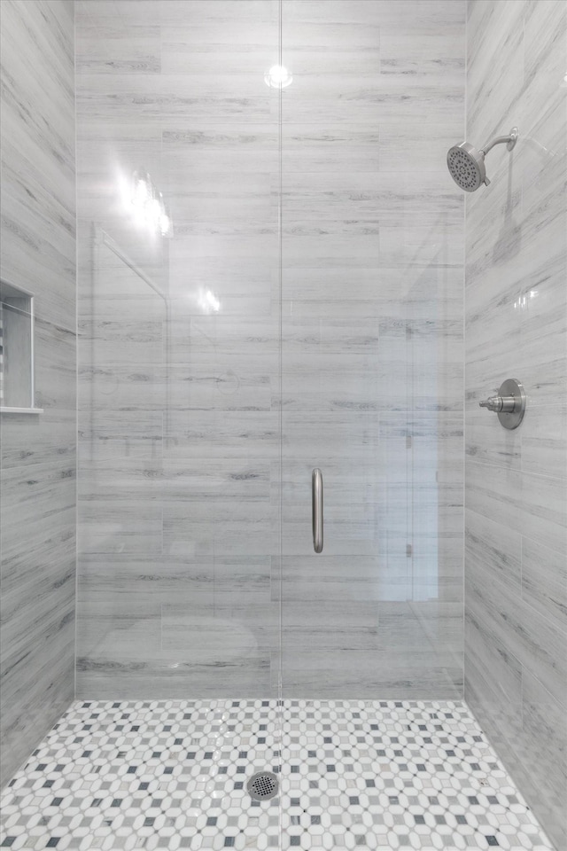 bathroom with a shower with shower door