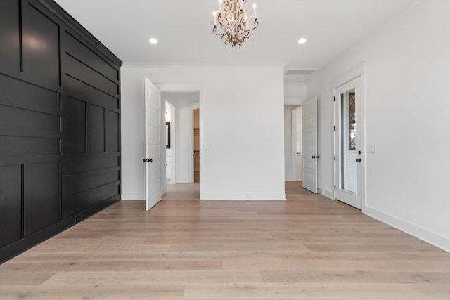 hall featuring an inviting chandelier and light hardwood / wood-style flooring