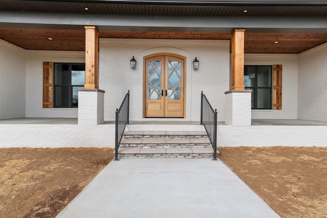 view of exterior entry with covered porch