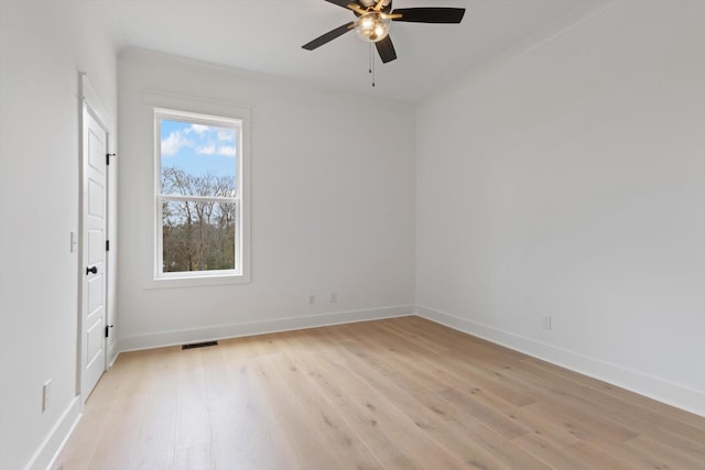 unfurnished room featuring ceiling fan, light hardwood / wood-style floors, and ornamental molding