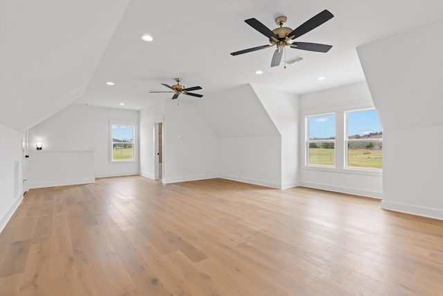 bonus room featuring ceiling fan, vaulted ceiling, and light wood-type flooring