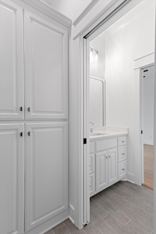 bathroom featuring vanity and wood-type flooring