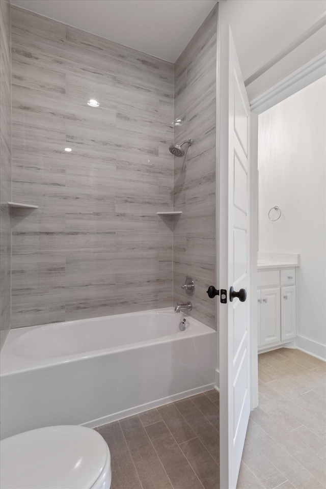 full bathroom featuring bathtub / shower combination, vanity, and toilet