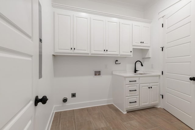 laundry area featuring washer hookup, hookup for an electric dryer, cabinets, and sink