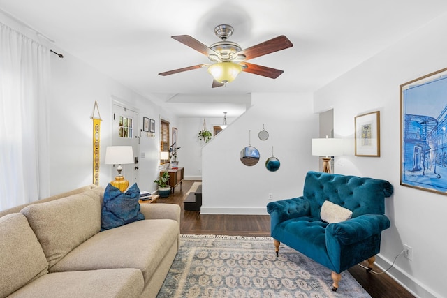 living room with ceiling fan and dark hardwood / wood-style flooring