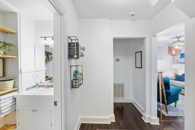 corridor featuring dark hardwood / wood-style floors and sink