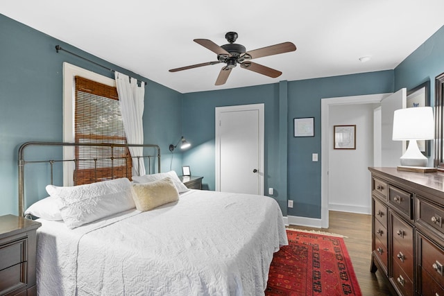 bedroom with ceiling fan and dark wood-type flooring