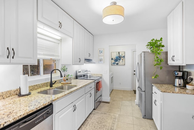 kitchen with light stone countertops, sink, white cabinets, and stainless steel appliances