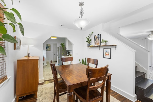 dining area with dark hardwood / wood-style flooring and ceiling fan