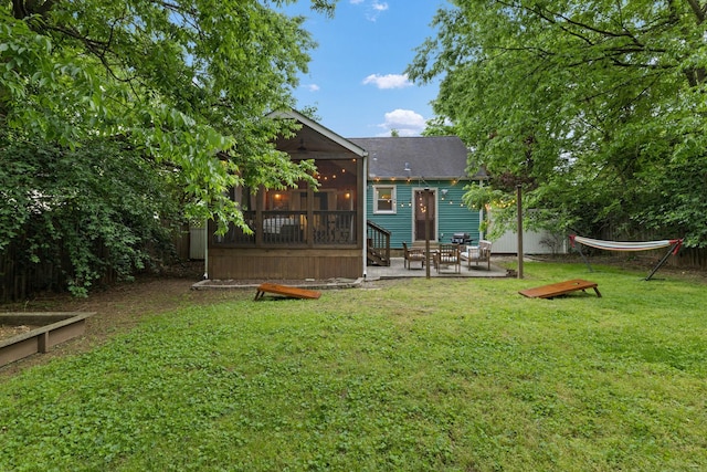 view of yard with a sunroom and a patio area