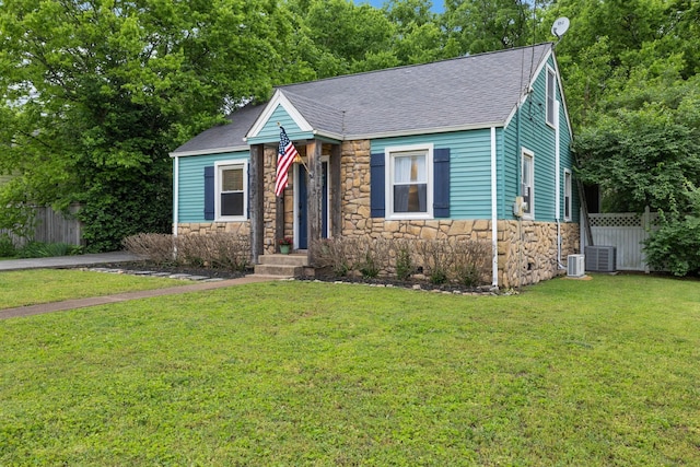 view of front facade with central AC and a front lawn