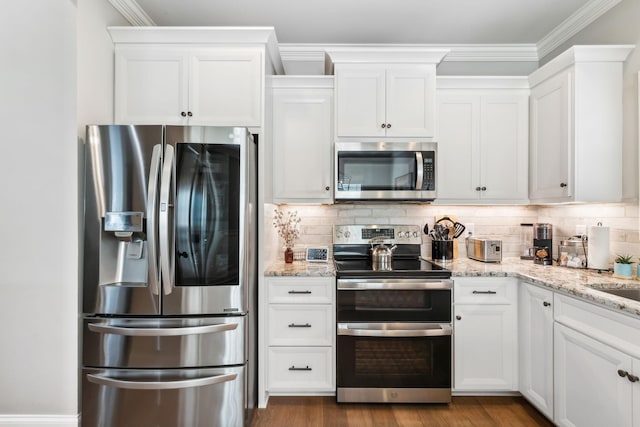 kitchen featuring white cabinets, crown molding, and stainless steel appliances