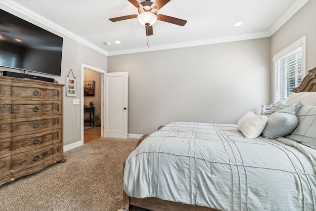 carpeted bedroom featuring ceiling fan and crown molding