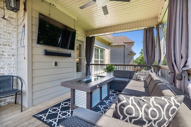 wooden terrace with ceiling fan and an outdoor hangout area