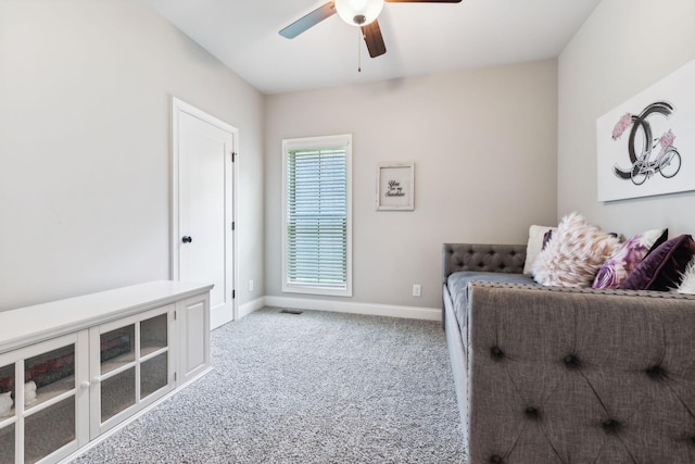 sitting room with ceiling fan and light colored carpet