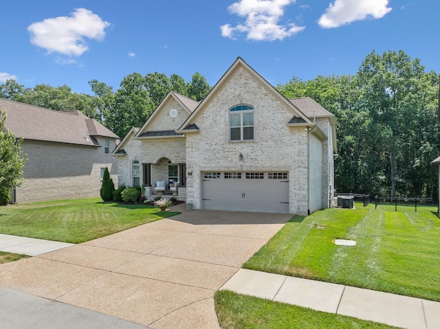 view of front of property with central AC unit, a garage, and a front yard