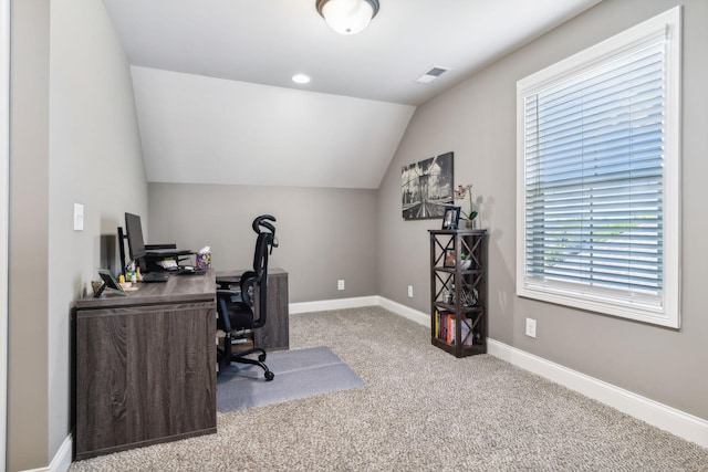 office area featuring light colored carpet and lofted ceiling