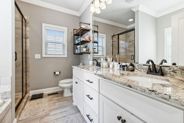 bathroom featuring hardwood / wood-style floors, vanity, crown molding, and walk in shower