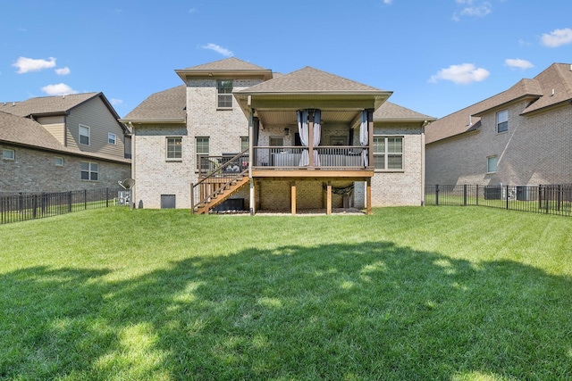 rear view of house with a lawn and a wooden deck