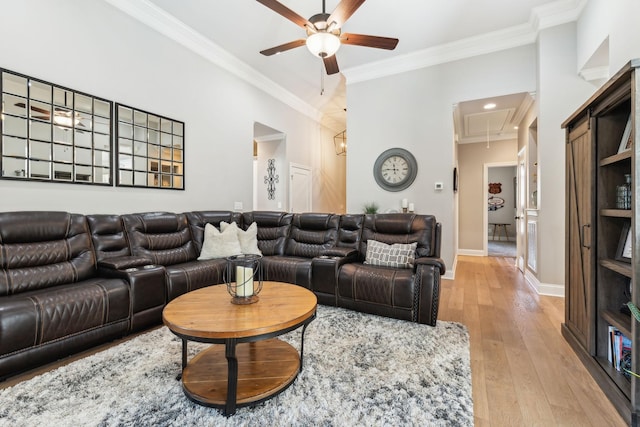 living room featuring ceiling fan, light hardwood / wood-style flooring, and ornamental molding