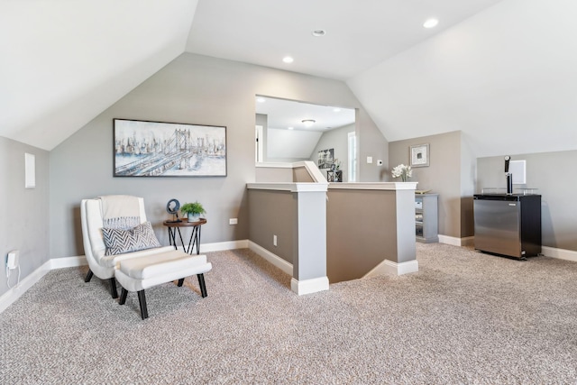 sitting room featuring carpet floors and lofted ceiling